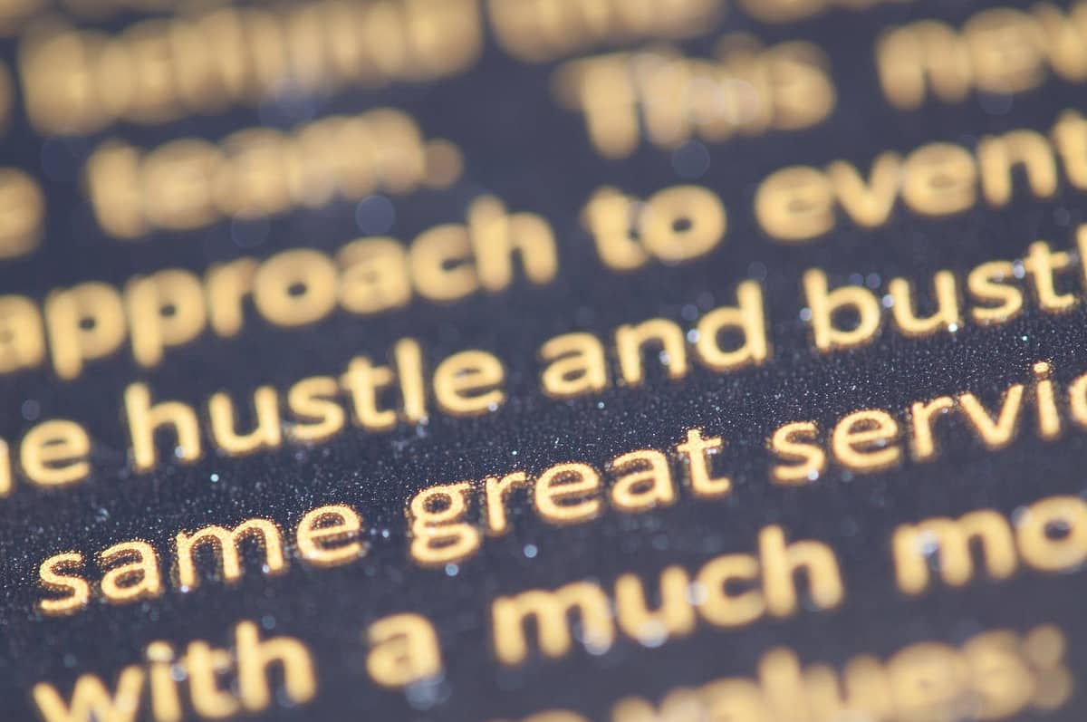 selective focus photography of hustle and bust text